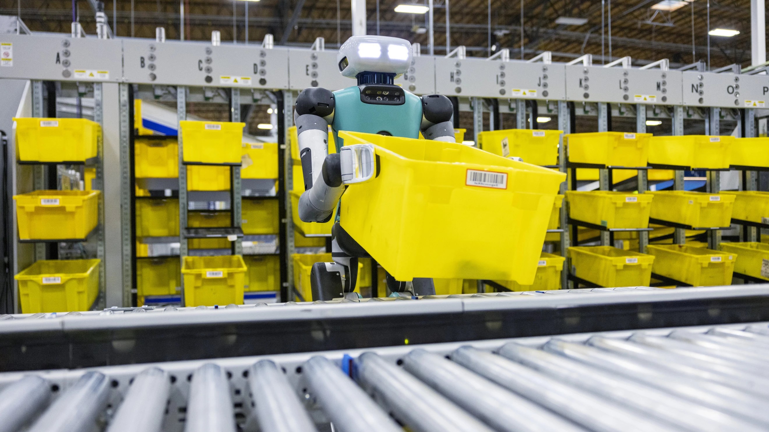 Amazon Agility Robotics Digit handling a tub in a warehouse
