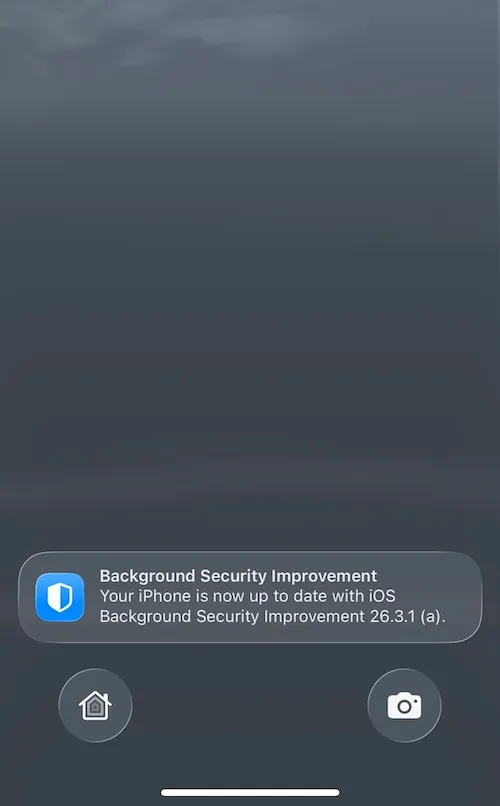 a screenshot showing an iPhone home/lock screen after a restart. A notification reads: "Background Security Improvement Your iPhone is now up to date with ioS Background Security Improvement 26.3.1 (a)."